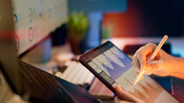 Person sketching on a tablet